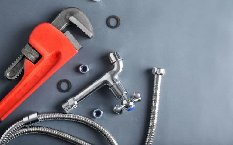 Plumber's Items On Grey Background — Plumbers in Mittagong, NSW