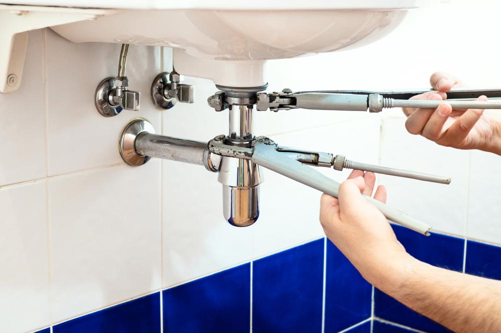 Plumber Repairing Sink Siphon — Plumbers in Bundanoon, NSW