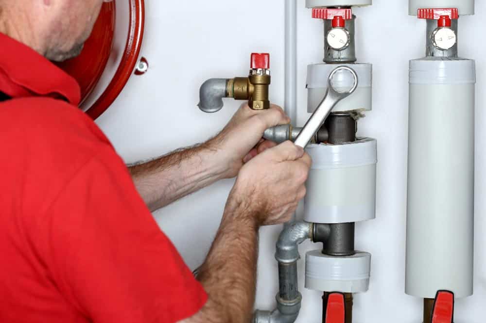 Plumber With Metal Wrench — Plumbers in Exeter, NSW